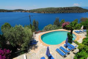 a swimming pool with a view of a lake at Dimitra Apartments in Milina