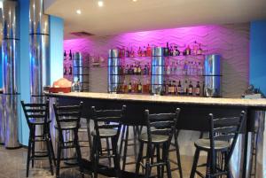 a bar with a bunch of bar stools in a room at Mercury Hotel-Premium All Inclusive in Sunny Beach