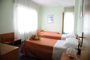 Ένα ή περισσότερα κρεβάτια σε δωμάτιο στο Hotel Tre Castelli