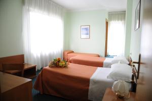 A bed or beds in a room at Hotel Tre Castelli