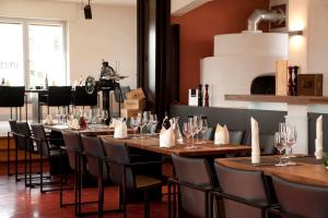 a row of tables and chairs in a restaurant at Villa Behr in Wendlingen am Neckar
