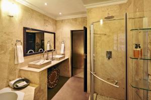 a bathroom with a shower and a sink at Vuyani Safari Lodge in Hoedspruit