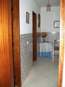 a hallway with a table in a room at Pacheco's Guesthouse in Lagos