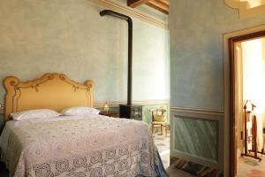 a bedroom with a bed and a fireplace at Podere Pradarolo in Varano deʼ Melegari