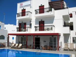 a building with a swimming pool in front of it at Iliovasilema in Naxos Chora