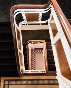 
a stair case that has a bunch of pieces of luggage on it at Kloosterhotel de Soete Moeder in Den Bosch
