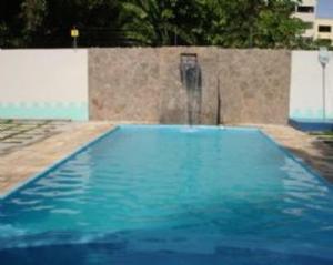 uma piscina azul com uma fonte de água em Ferrari Palace Hotel em Boa Vista