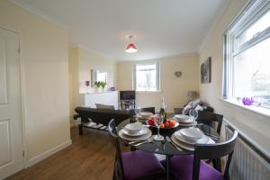 a dining room with a table and chairs at PREMIER - Park View Apartment in Paisley
