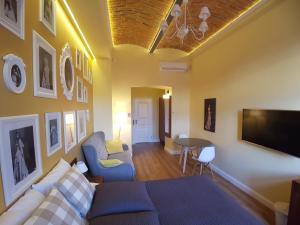 a living room with a couch and a tv at Apartamenty Czapskich in Kraków +108 photos