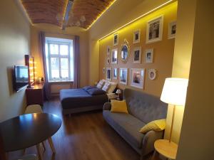 a living room with a couch and a table at Apartamenty Czapskich in Kraków