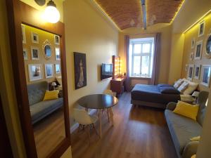 a living room with a couch and a table at Apartamenty Czapskich in Krakow