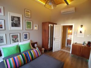 a living room with a couch and some pictures on the wall at Apartamenty Czapskich in Krakow