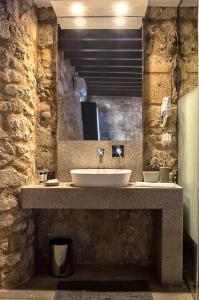 a bathroom with a sink and a mirror at Trinity Boutique Hotel in Rhodes Town