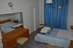 a bedroom with a bed and a desk and a mirror at Cosy apartment Acropolis Point 2 in Athens