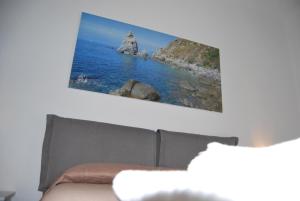 uma televisão pendurada numa parede acima de um sofá em Le Mulinare - Bed & Breakfast em Drapia