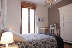 a bedroom with a bed and a chandelier at Goga&Romeo in Pesaro