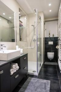 a bathroom with a shower and a sink and a toilet at Happy Guest Apartment Zagreb in Zagreb