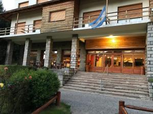 a building with a flag on top of it at Hotel Alun Nehuen in San Carlos de Bariloche