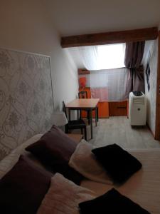 um quarto com uma cama e uma mesa com uma janela em Chambres d'Hôtes Roseland em Paray-le-Monial