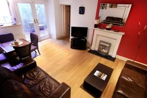 a living room with a couch and a fireplace at Regent House Hotel - City Centre Hotel in Edinburgh