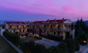 an aerial view of a mansion at dusk at Eliton Hotel & Spa in Kato Loutraki