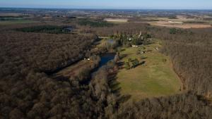 an aerial view of a farm and a river at Yourte d'Aiguevives in Céré-la-Ronde