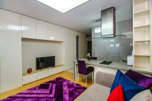 a living room with a purple rug at Highvill Deluxe Apartments in Astana