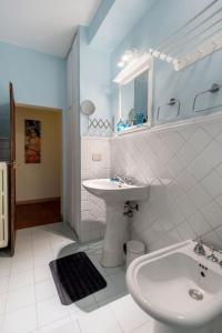 a white bathroom with a sink and a toilet at Atmosfere Rinascimentali in Florence