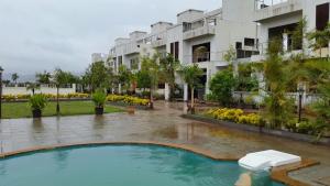 a swimming pool in front of a building at Modern Villa One in Lonavala +12 photos