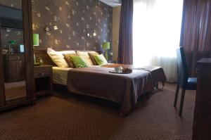 a hotel room with a bed and a window at Willa Magnolia in Gdynia