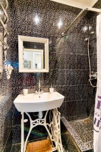 a bathroom with a sink and a mirror and a shower at Stylish Studio near Rynok square in Lviv