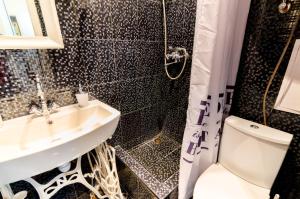 a bathroom with a sink and a toilet and a shower at Stylish Studio near Rynok square in Lviv