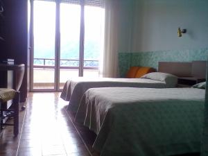 Postel nebo postele na pokoji v ubytování Hotel Glavjc