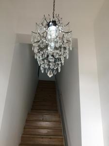 a chandelier hanging from a staircase in a house at ValentinaPlace in Alcácer do Sal
