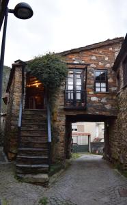 a stone building with stairs leading up to it at Casa da Cerejinha in Góis