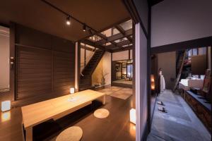 uma sala de estar com um banco de madeira num quarto em Kiraku Kyoto Aneyakoji em Quioto