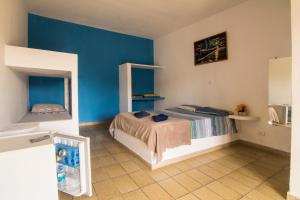a bedroom with a bed and a blue wall at Hotel Marina Clube de Pesca in Cananéia +37 photos