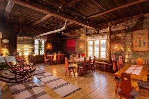 a dining room with tables and chairs in a building at Peltolan Luomutila in Vilppula
