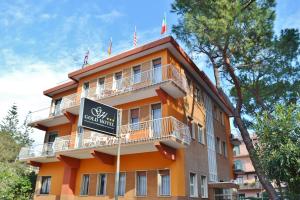 an orange building with a sign in front of it at Gold Hotel in Bordighera