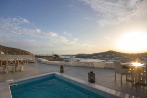a swimming pool on a roof with a view of the ocean at Anixi Lounge Suites - Adults Only in Ornos