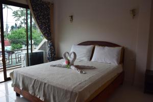 Postel nebo postele na pokoji v ubytování Samui Guest House