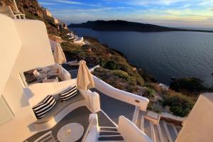 a view of the ocean from a balcony of a house at Finesse Suites in Oia
