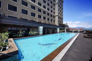 a large swimming pool in front of a building at Fullon Hotel Hualien in Hualien City