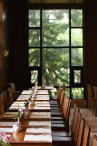una mesa larga en una habitación con sillas y ventanas en Fullon Hotel Hualien, en Hualien City