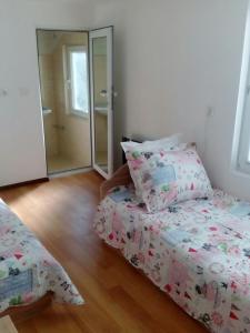 a bedroom with a bed and a mirror at Magnolia Guest house in Haskovo
