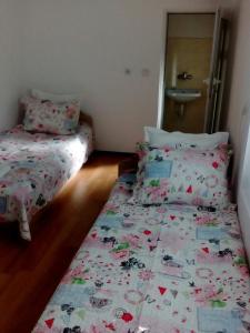 a bedroom with two beds and a bedspread with hearts at Magnolia Guest house in Haskovo