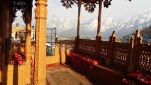a balcony with a view of snow covered mountains at Jacqueline houseboat in Srinagar