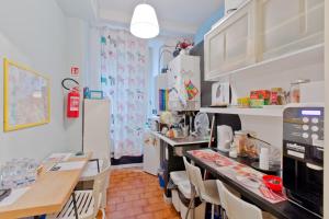 a kitchen with a table and chairs and a counter at Oscar Rooms in Rome