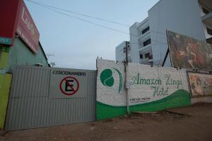 a fence with a no parking sign next to a building at Amazon Xingu Hotel in Altamira