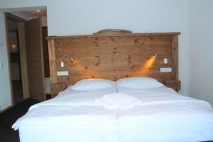 a large white bed with two pillows on it at Ferienhaus Fassl in Saalbach Hinterglemm